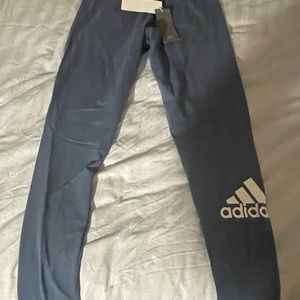 Adidas Tights with logo on the leg they are a blue light navy in color